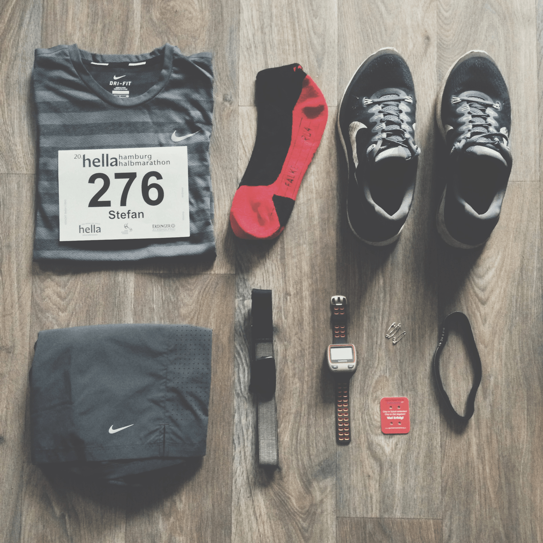 A bunch of running gear layed down in preparation for a running event