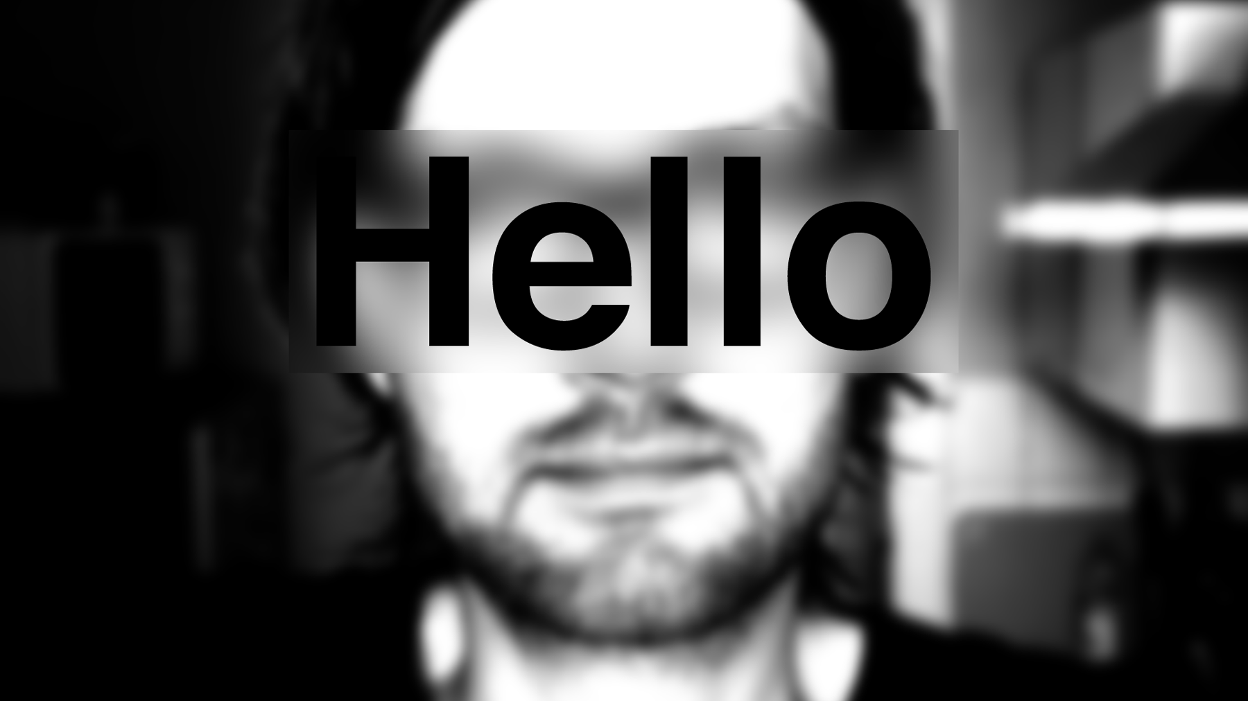 A blurred black and white portrait image with the words hello world on top
