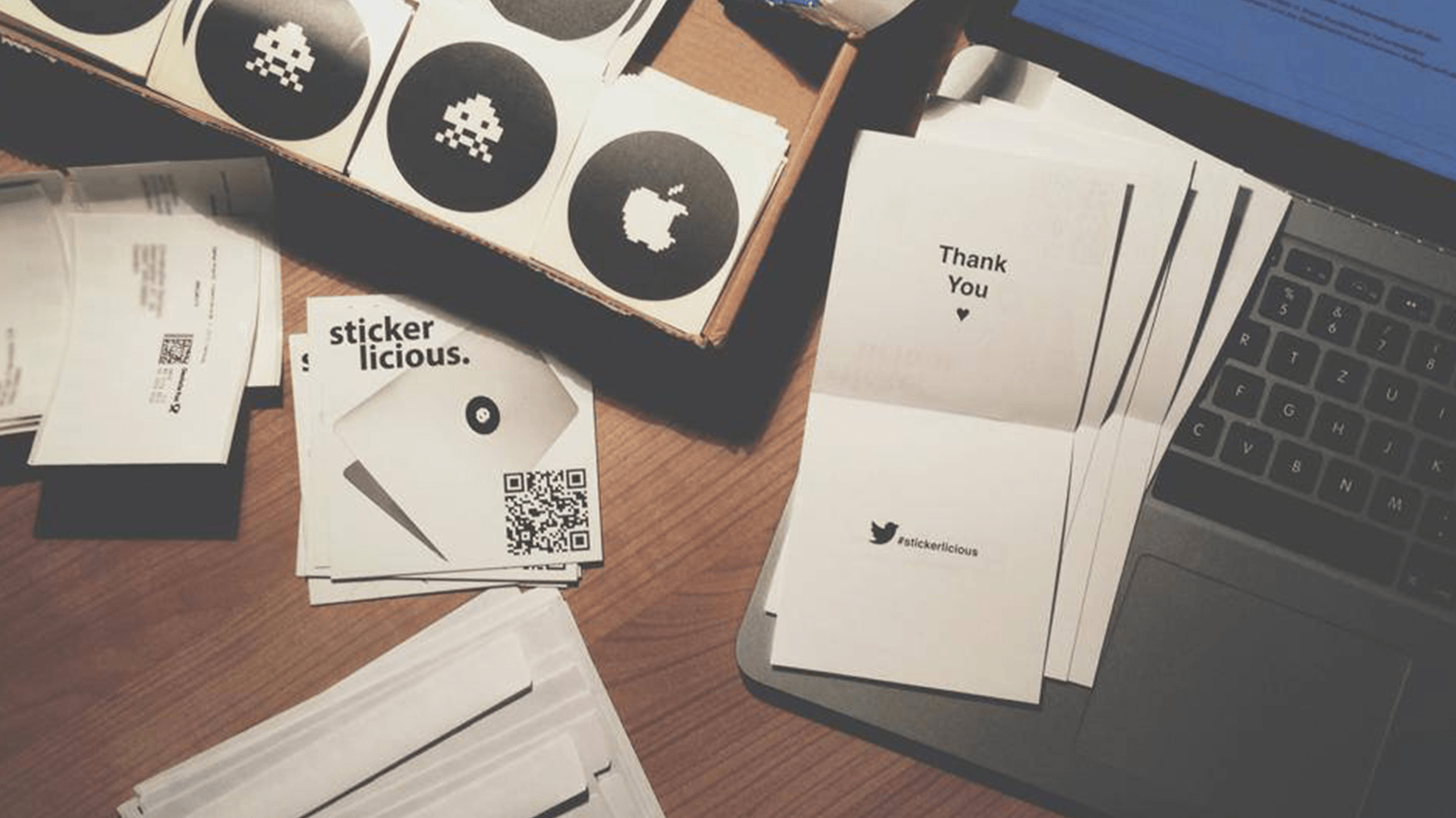 A desk full of stickers and packaging material